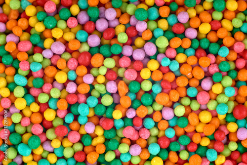 Colorful candies background  copy space. Nuts in multi-colored glaze dragee. Sweet candies spreading pastry decoration. Pile of colorful coated candy. Sweets  texture  pattern. Top view  flat lay