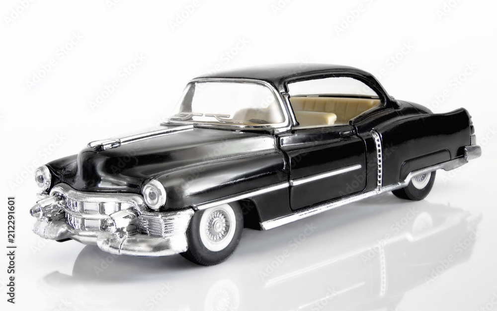 The classical American car of 1952 of release of black color on a white background with reflection. The classical American car of 1952 of release of black color on a white background with reflection.