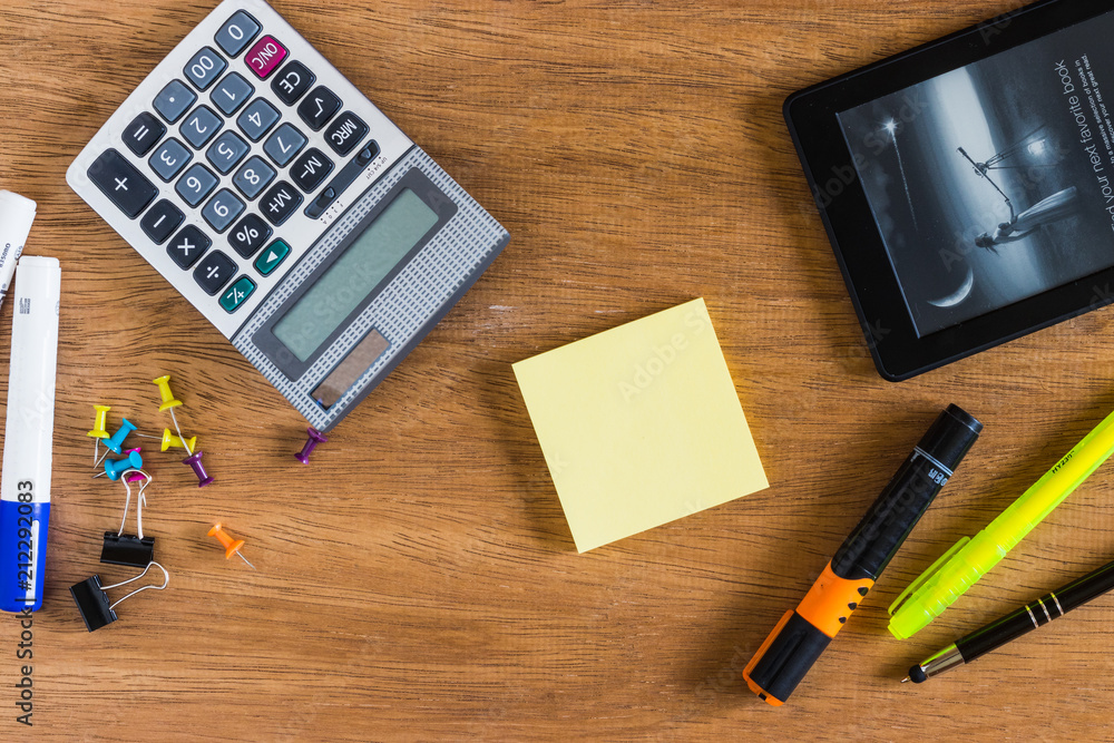 Countant supplies like calculator and markers on a wooden background Countant supplies like calculator and markers on a wooden background