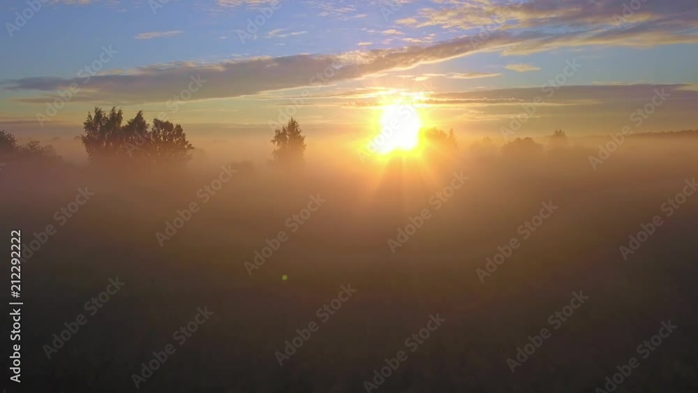 Beautiful aerial shot of thick layer of fog on fields during sunrise with expanse and endless skyline