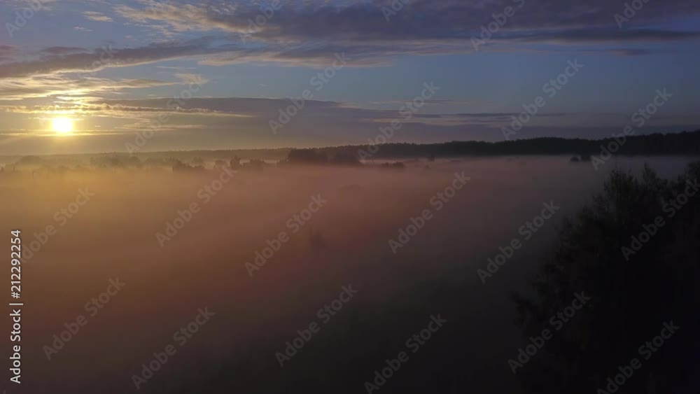 Beautiful aerial shot of thick layer of fog on fields during sunrise with expanse and endless skyline Beautiful aerial shot of thick layer of fog on fields during sunrise with expanse and endless skyline