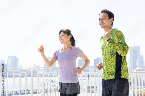 young asian couple running