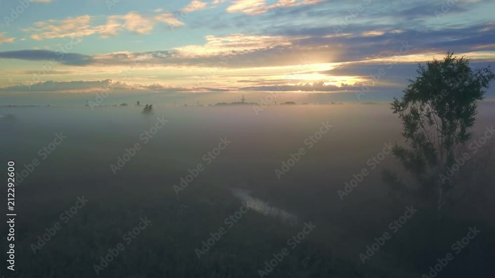 Beautiful aerial shot of thick layer of fog on fields during sunrise with expanse and endless skyline Beautiful aerial shot of thick layer of fog on fields during sunrise with expanse and endless skyline