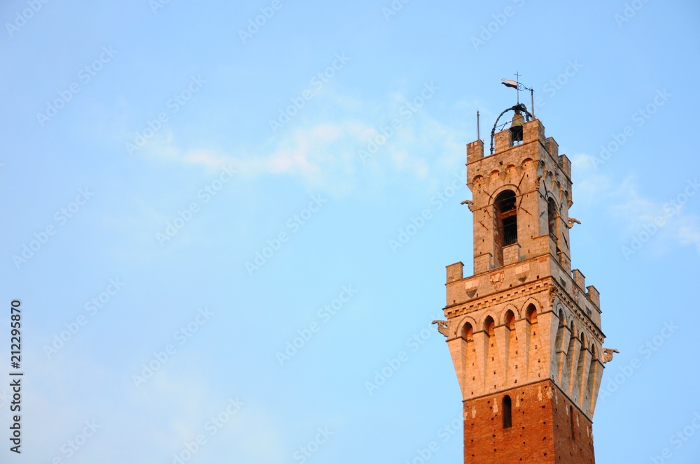 Sunset view of Torre del Mangia Tower of City Hall in Siena, Tuscany, Italy