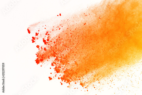 abstract orange powder splashed on white background. Colorful powder explosion isolte background. Colored cloud. Colorful dust explode. Paint Holi.