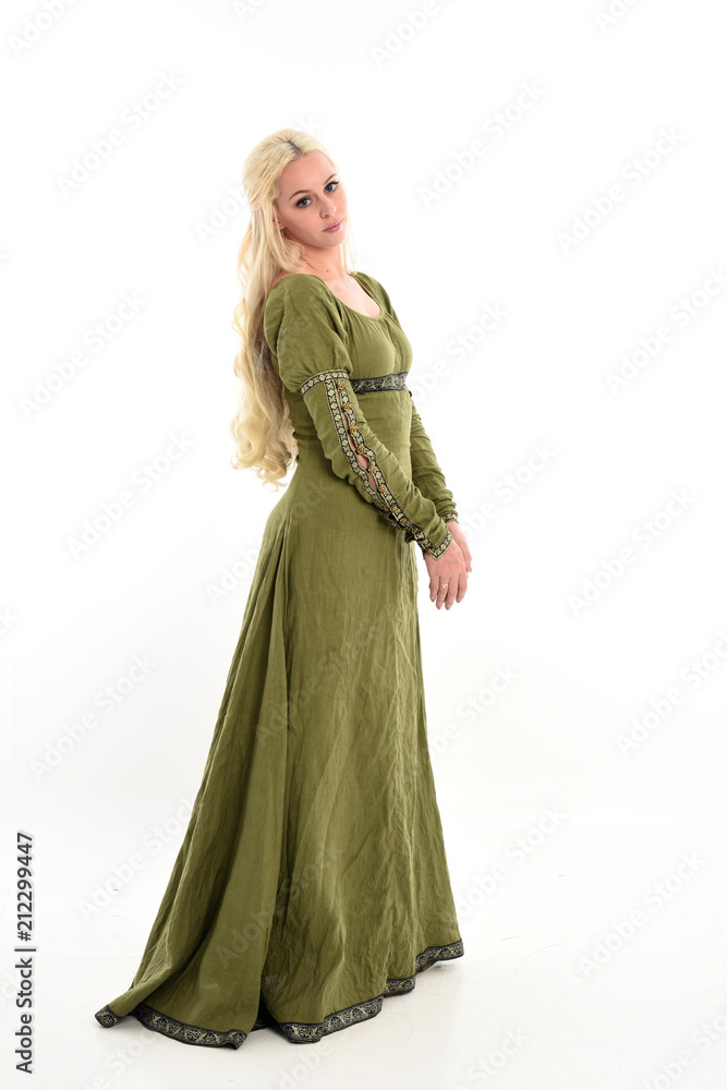 full length portrait of a blonde girl wearing green medieval gown, stand pose, isolated on white studio background. full length portrait of a blonde girl wearing green medieval gown, stand pose, isolated on white studio background.