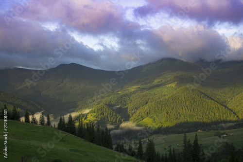 Photo of mountain landscape in the summer under beautiful cloudy sky. Ukraine  Carpathians  Dzembronia village.