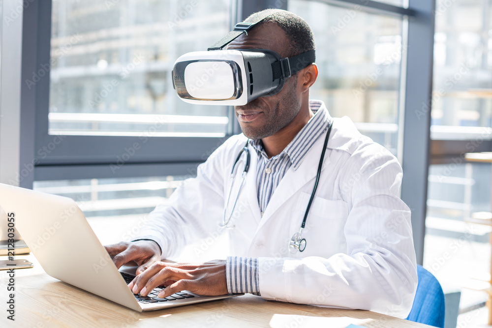 Competent young practitioner testing VR glasses Competent young practitioner testing VR glasses