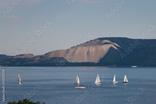 white sailboats on the background of mountains
