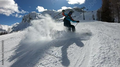 Young boy skiing.
A man enjoys skiing in the Alpine resort. Skier spraying snow into the camera. Stabilized footage. Slow motion.