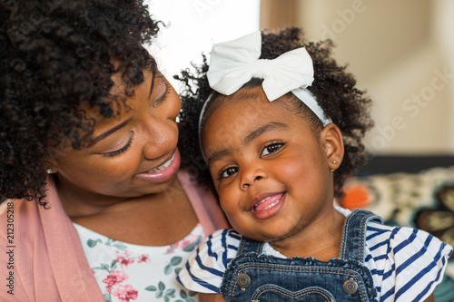 African American family. Mother and daughter smiling at home.