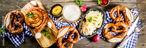 Vászonkép Oktoberfest food menu, bavarian sausages with pretzels, mashed potato, sauerkrau