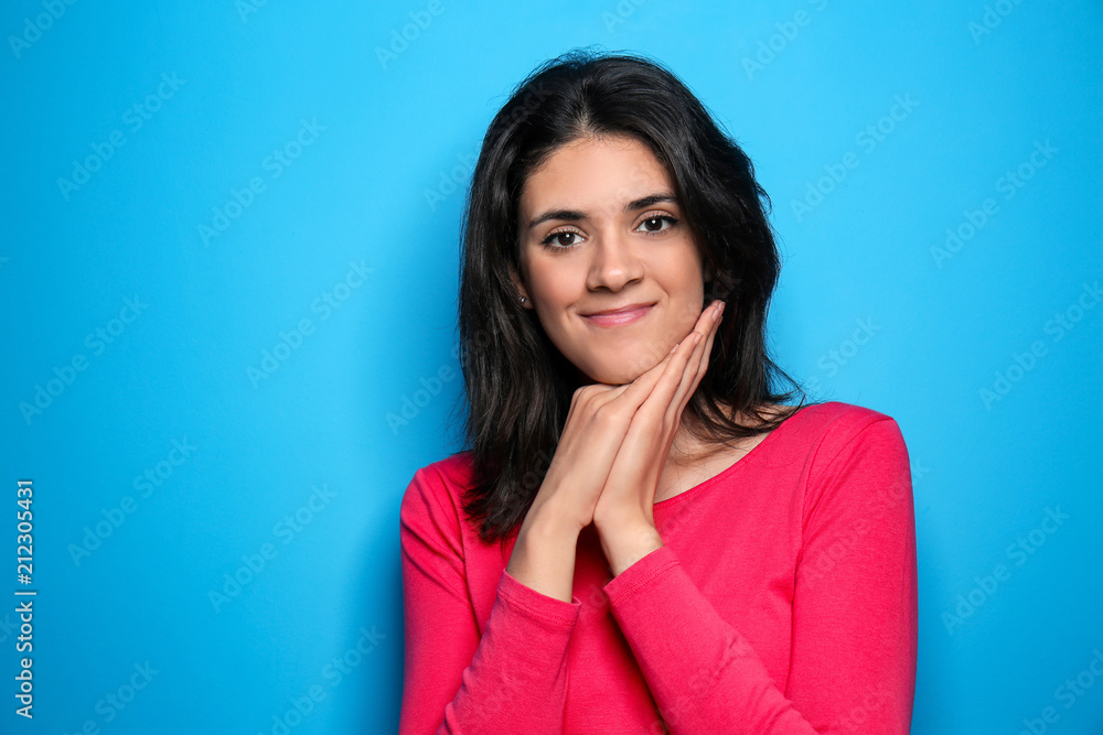 Attractive young woman posing on color background Attractive young woman posing on color background