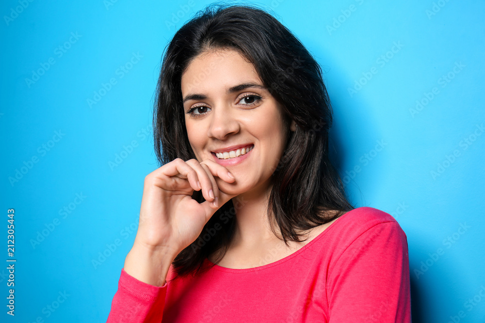 Attractive young woman posing on color background Attractive young woman posing on color background