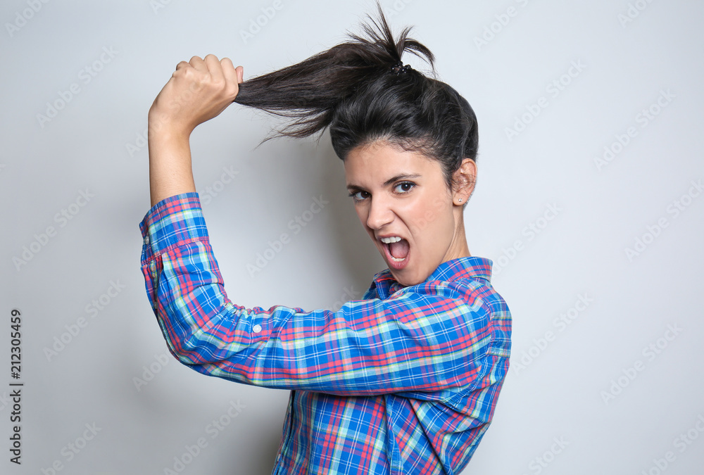 Fototapeta premium Attractive young woman posing on light background