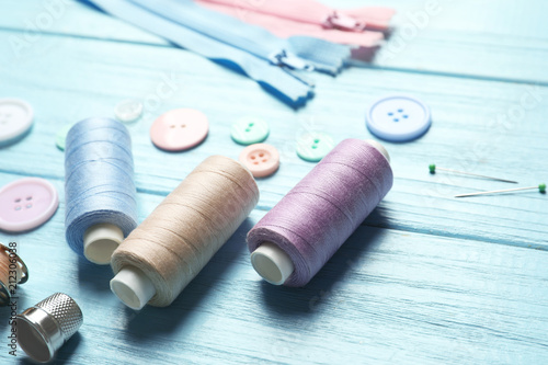 Set of tailoring accessories on wooden background