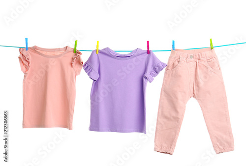 Child clothes on laundry line against white background