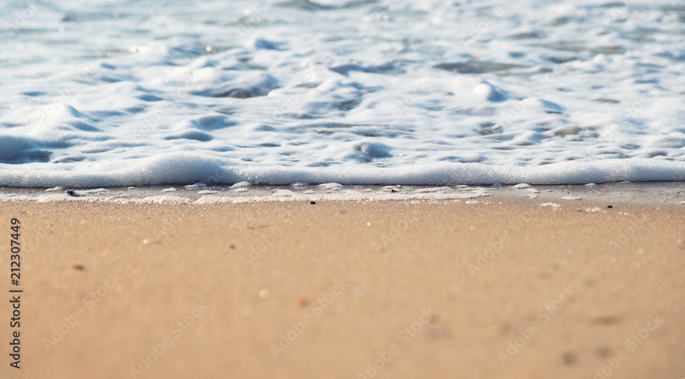 Wave and sand as a background. Beautiful natural composition at the summer time Wave and sand as a background. Beautiful natural composition at the summer time