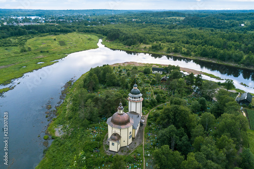 Top view of Orthodox Church Of The Resurrection and Vazhinka river. Kurpovo village in Vazhinsky urban settlement of Podporozhsky district of Leningrad region, Russia. photo