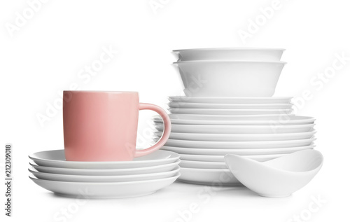 Stacks of ceramic dishware on white background