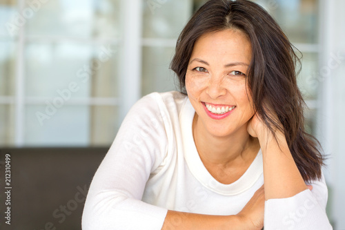 Portrait of an Asian woman smiling. Free Download Portrait of an Asian woman smiling. - GFXLoad