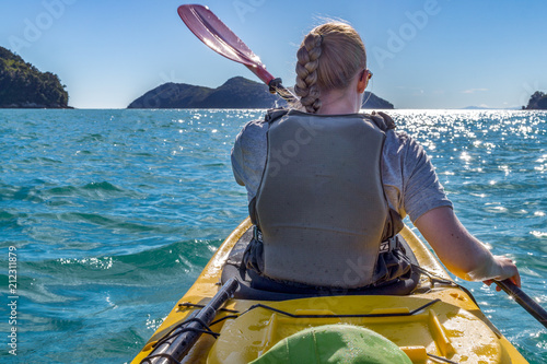 Woman kayaking at sea during summer