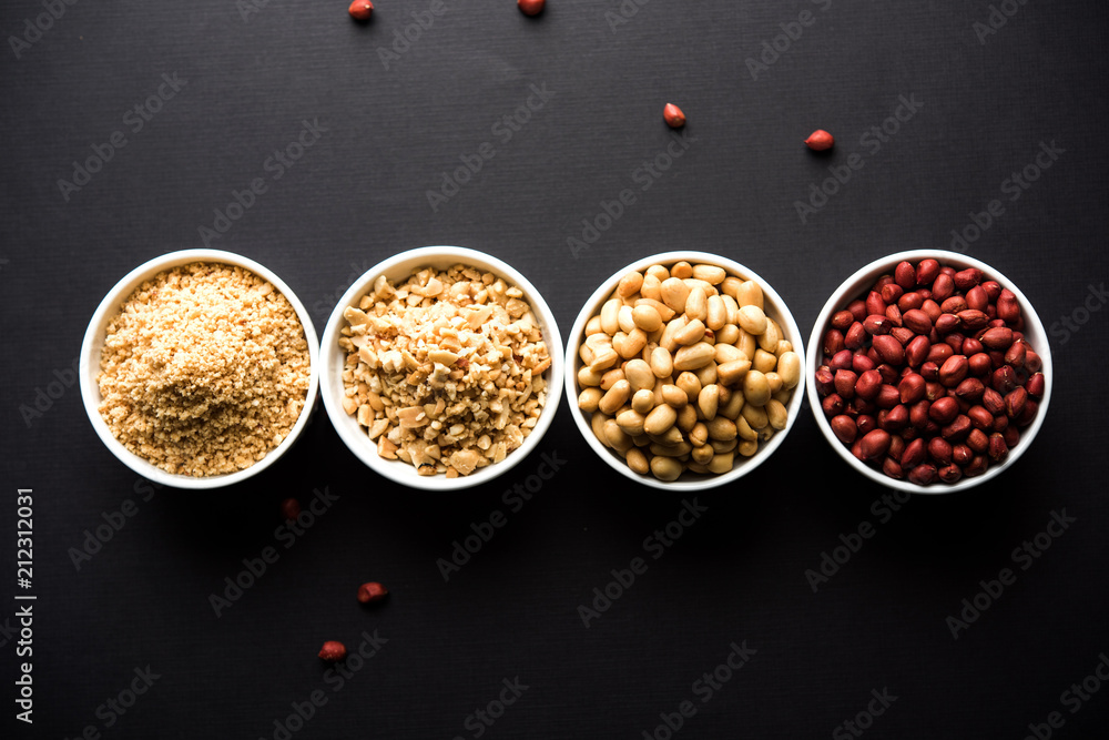 Crushed peanuts or mungfali powder with whole and roasted groundnut. Served in a bowl over moody background. Selective focus Crushed peanuts or mungfali powder with whole and roasted groundnut. Served in a bowl over moody background. Selective focus
