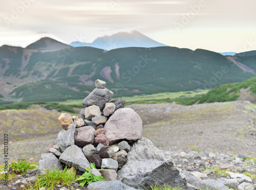 Evening on the territory of the nature Park Nalychevsky. A pyramid of stones made by tourists as a milestone indicating the direction of movement © njr_2018