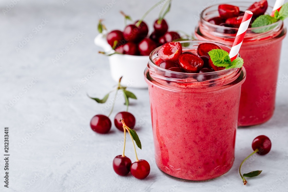 Cherry smoothie in glass with mint leaves and fresh berries Cherry smoothie in glass with mint leaves and fresh berries