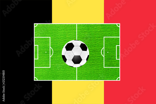 football on the background of the field and the flag of Belgium