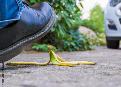 a pedestrian will slip on a discarded banana peel
 photo