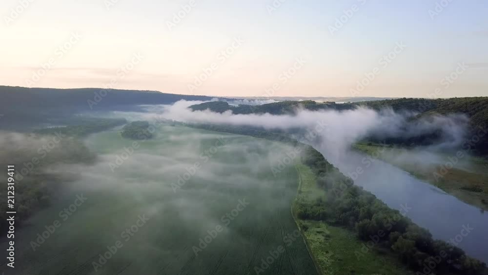 River and field in the mist during sunrise. Natural aerial landscape at the summer time River and field in the mist during sunrise. Natural aerial landscape at the summer time