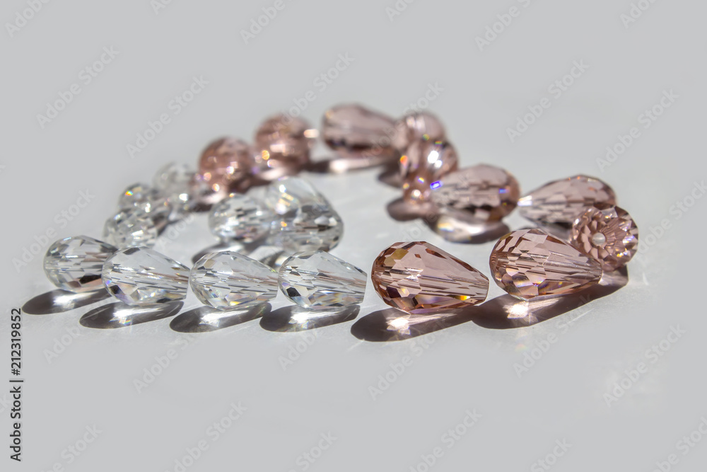 Glass beads collected in a heart shape on a white background isolated. Glass beads collected in a heart shape on a white background isolated.