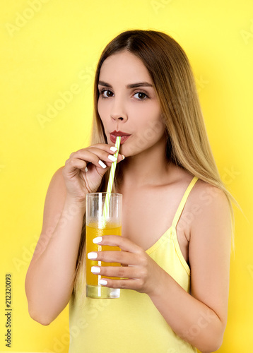 Young blonde woman drinking juice