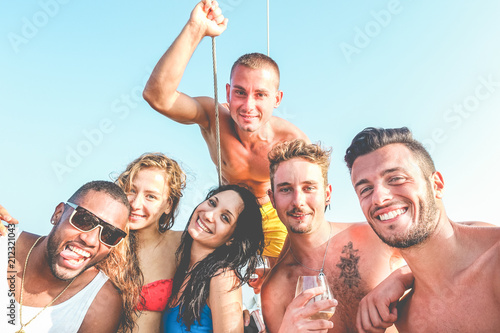 Group of multiracial friends having fun in boat summer party