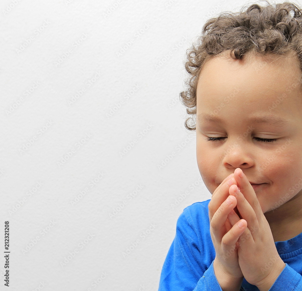 boy praying with closed eyes stock photo boy praying with closed eyes stock photo