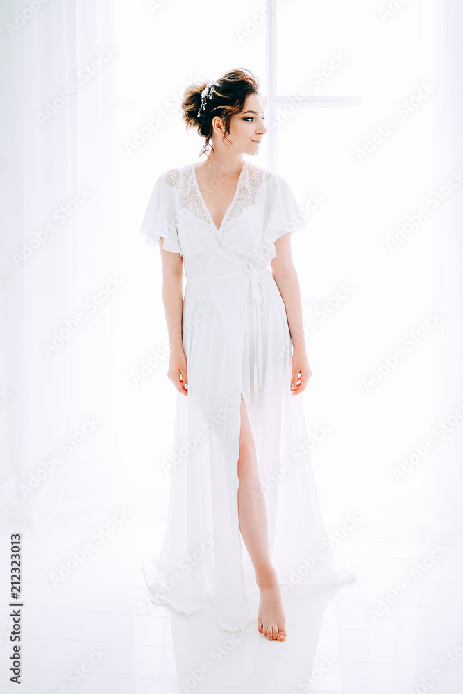 Tender elegant young bride with hairdo, hairpin and bridal makeup