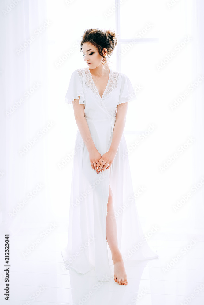 Tender elegant young bride with hairdo, hairpin and bridal makeup Tender elegant young bride with hairdo, hairpin and bridal makeup