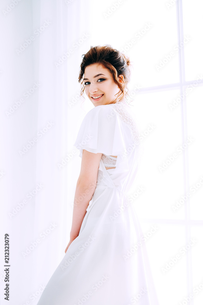 Tender elegant young bride with hairdo, hairpin and bridal makeup Tender elegant young bride with hairdo, hairpin and bridal makeup
