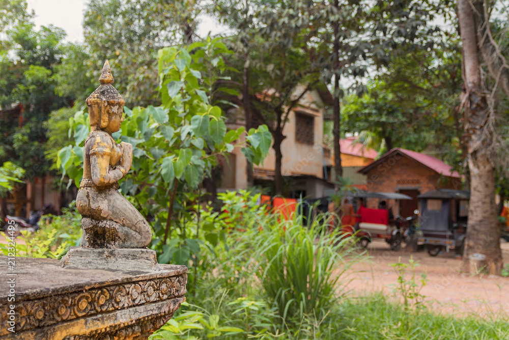 detail of decorative ornaments of golden stupa with a tuk tuk in the background in buddhist temple in cambodia detail of decorative ornaments of golden stupa with a tuk tuk in the background in buddhist temple in cambodia