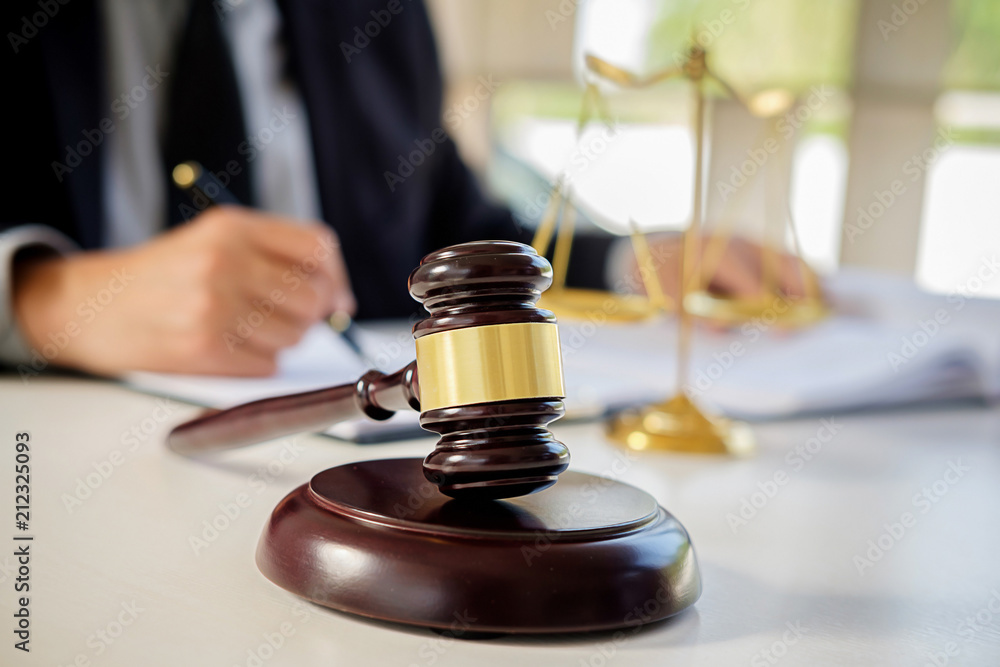 Judge gavel with Justice lawyers having team meeting at law firm in background. Concepts of law. Judge gavel with Justice lawyers having team meeting at law firm in background. Concepts of law.