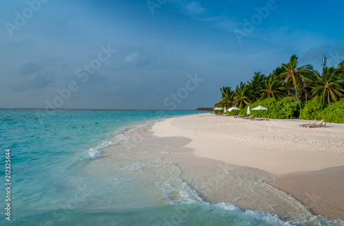 Ocean waves on the perfect beach. Beach bungalow. Luxury escape. Tropical paradise. Honeymoon at Maldives. Palms and white sund. Blue ocean  © Maria