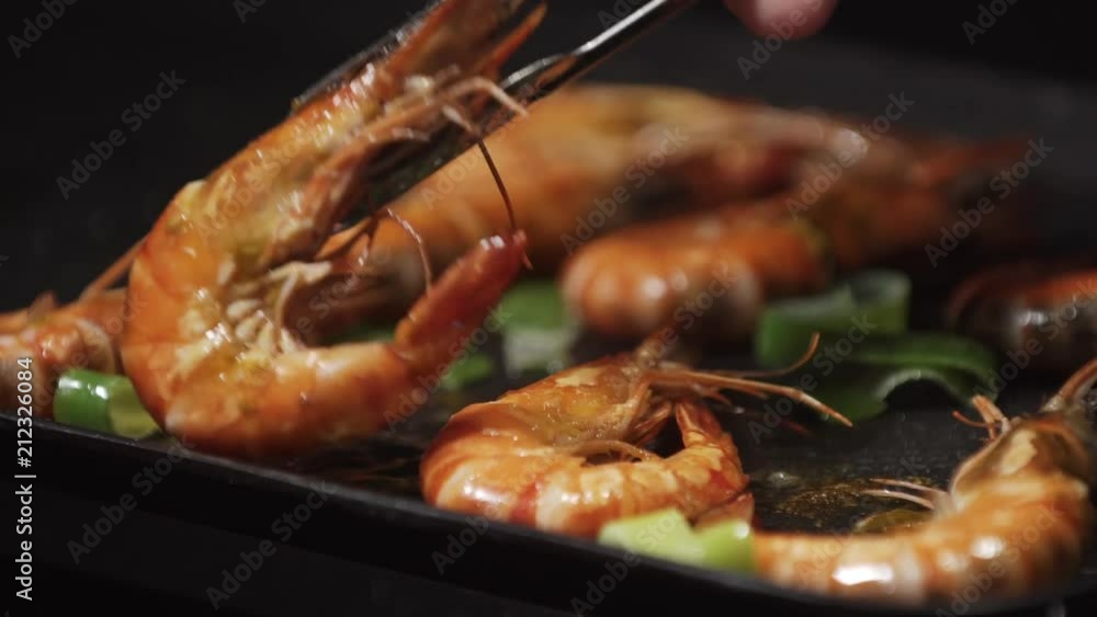 Grilling and fried shrimps on electric barbecue. Healthy Grilled seafood on bbq. Closeup of grilled red shrimps on barbecue grill. Hot prawns grilling bbq Grilling and fried shrimps on electric barbecue. Healthy Grilled seafood on bbq. Closeup of grilled red shrimps on barbecue grill. Hot prawns grilling bbq