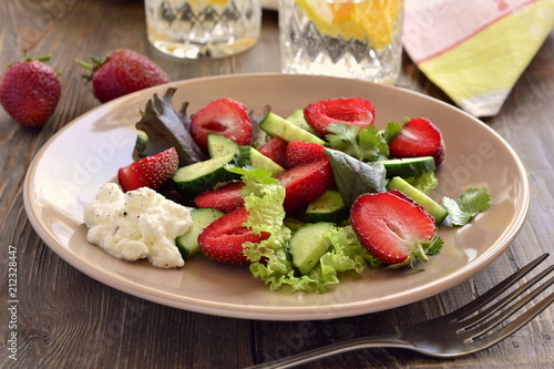 Strawberry salad with cucumber and  lettuce with yogurt sauce