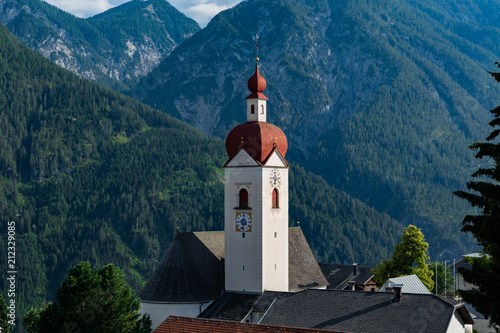 30 june 2018: View of the little village of Assling (Tyrol region, Austria) with the Tyrolean alps in the background