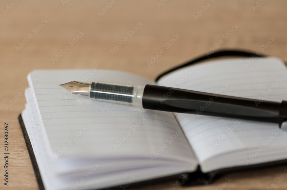 Fountain pen on a notebook Fountain pen on a notebook
