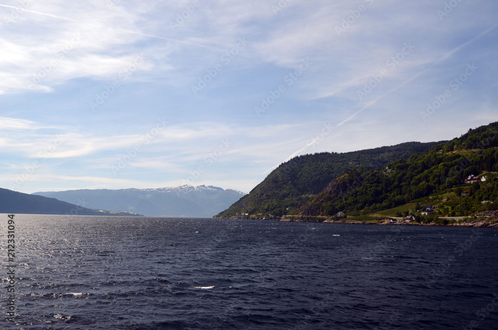 Mountains and fjord in Norway. Clouds and blue sky. Beautiful stunning views of mountains, water, sky, clouds and sun. Norwegian nature. Sognefjord
Mountains and fjord in Norway. Clouds and blue sky. Beautiful stunning views of mountains, water, sky, clouds and sun. Norwegian nature. Sognefjord