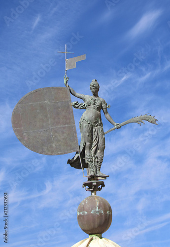 A bronze statue of the Faith with a banner in hand is installed on the tower of the Seville Cathedral in 1568. Sculptor Bartolome Morel. Spain, Seville, October 2016 photo