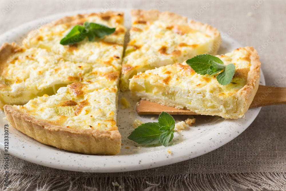 Pie with zucchini, cheese and mint on the table