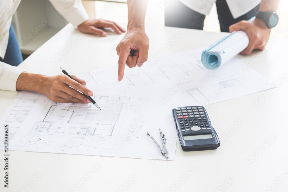Close-up Of Person's engineer Hand Drawing Plan On Blue Print with architect equipment, Architects discussing at the table, team work and work flow construction concept Close-up Of Person's engineer Hand Drawing Plan On Blue Print with architect equipment, Architects discussing at the table, team work and work flow construction concept